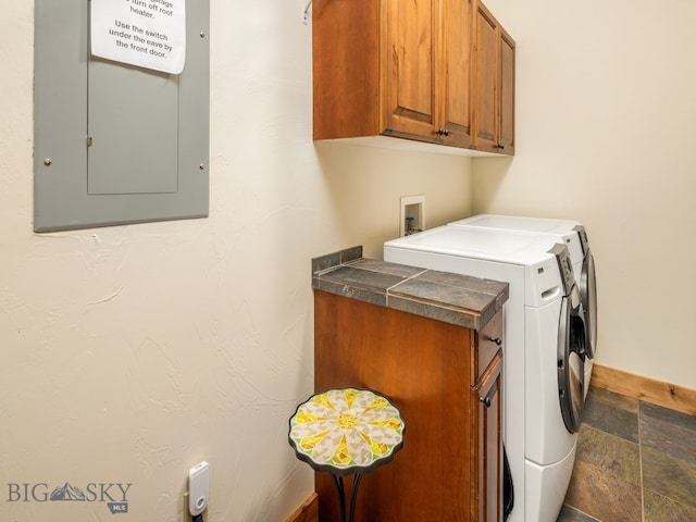 laundry area with washing machine and clothes dryer, cabinets, washer hookup, and dark tile flooring