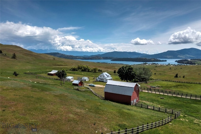 view of mountain feature with a rural view and a water view