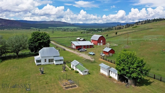 birds eye view of property with a mountain view and a rural view