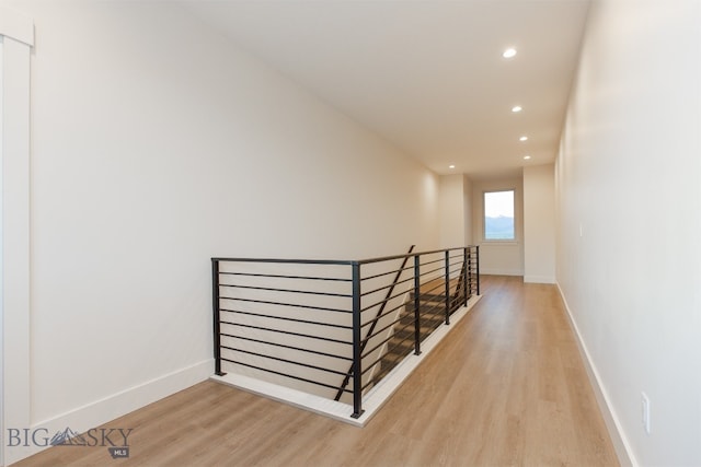 staircase with light hardwood / wood-style floors