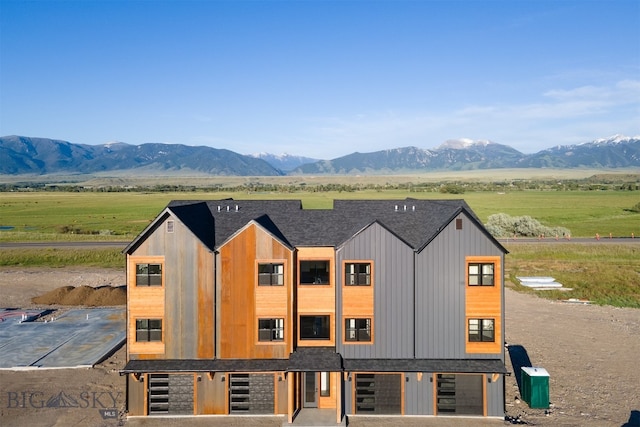 view of front of property featuring a mountain view and a rural view