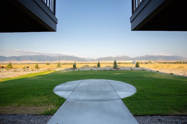 view of yard with a mountain view and a rural view