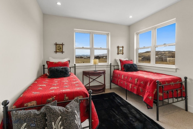 carpeted bedroom featuring baseboards and recessed lighting