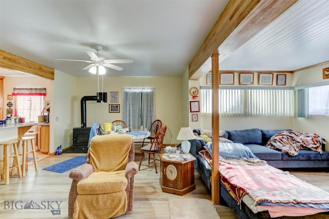 49 Two Dot Hwy, Harlowton, MT 59085 - living room featuring a wood stove, ceiling fan, plenty of natural light, and light wood-style floors