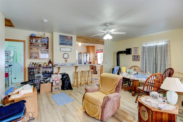 living room with ceiling fan and light hardwood / wood-style flooring