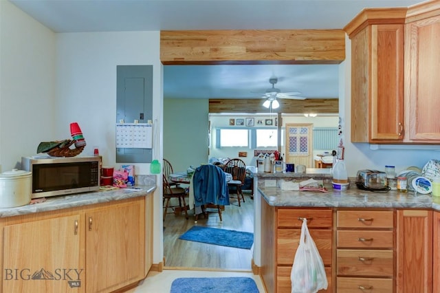 49 Two Dot Hwy, Harlowton, MT 59085 - kitchen with a peninsula, light wood-style floors, stainless steel microwave, and a ceiling fan
