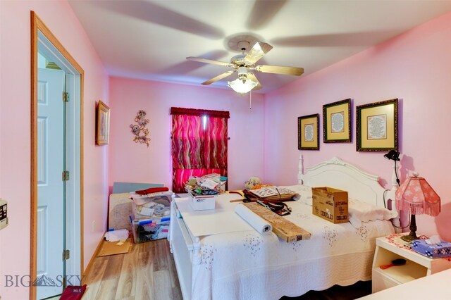 bedroom with light hardwood / wood-style flooring and ceiling fan