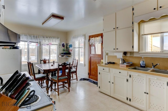 49 Two Dot Hwy, Harlowton, MT 59085 - kitchen featuring a sink, freestanding refrigerator, light countertops, and plenty of natural light