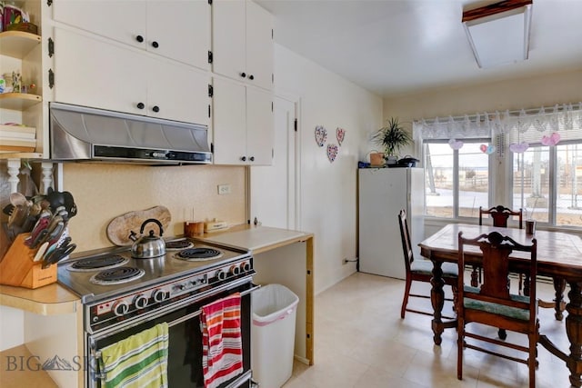 49 Two Dot Hwy, Harlowton, MT 59085 - kitchen with freestanding refrigerator, under cabinet range hood, white cabinetry, open shelves, and black range with electric stovetop