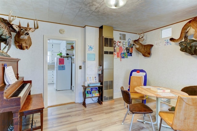 dining space with light hardwood / wood-style flooring