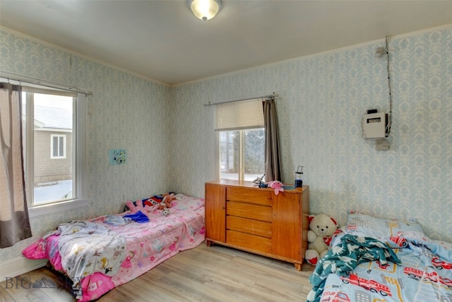 bedroom featuring light hardwood / wood-style flooring and multiple windows