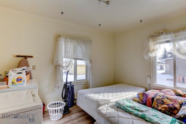 49 Two Dot Hwy, Harlowton, MT 59085 - bedroom featuring ornamental molding, washer and dryer, and wood finished floors