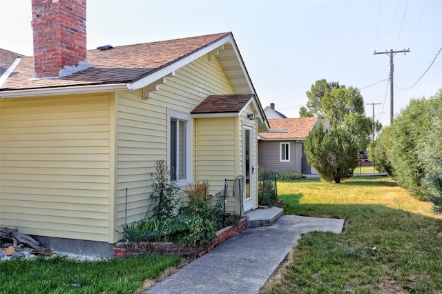 49 Two Dot Hwy, Harlowton, MT 59085 - view of home's exterior featuring a shingled roof, a chimney, and a lawn