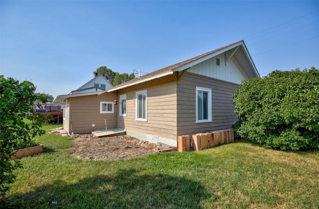 49 Two Dot Hwy, Harlowton, MT 59085 - back of property with crawl space, board and batten siding, and a lawn