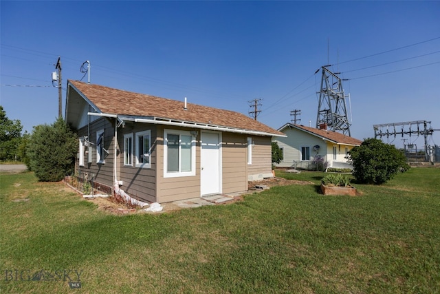 rear view of property with a lawn