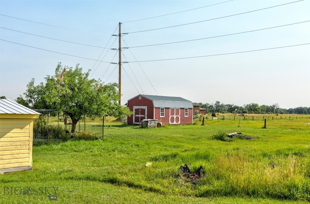 view of yard with an outdoor structure and a rural view