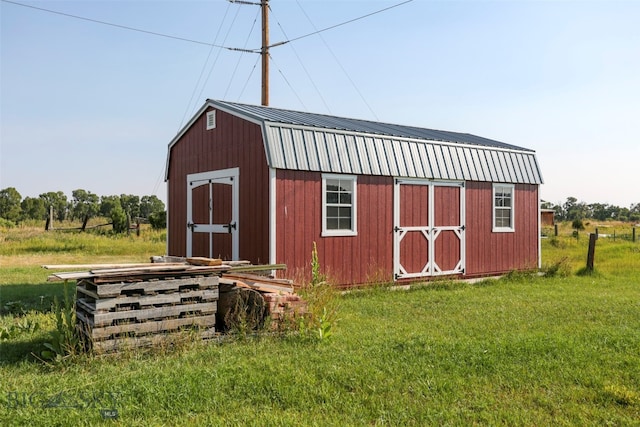 view of outbuilding featuring a lawn