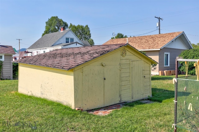 view of outbuilding with a yard