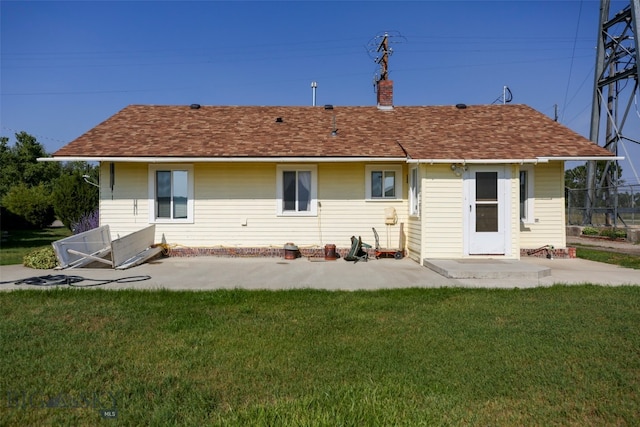 back of house with a yard and a patio area