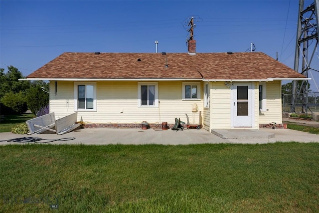 49 Two Dot Hwy, Harlowton, MT 59085 - rear view of house featuring a shingled roof, a yard, a chimney, and a patio