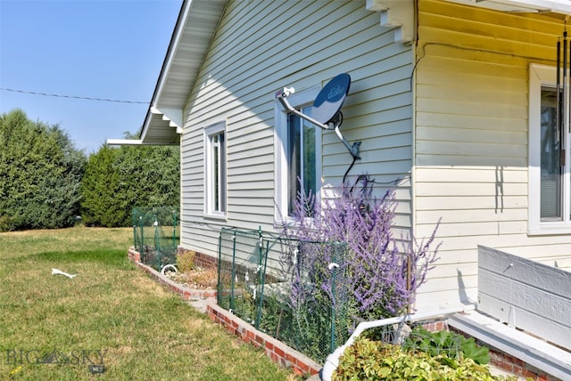 view of side of home with a lawn