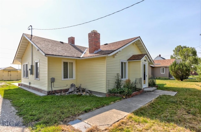 49 Two Dot Hwy, Harlowton, MT 59085 - exterior space with roof with shingles, a chimney, and a lawn
