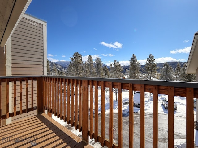 snow covered deck featuring a mountain view