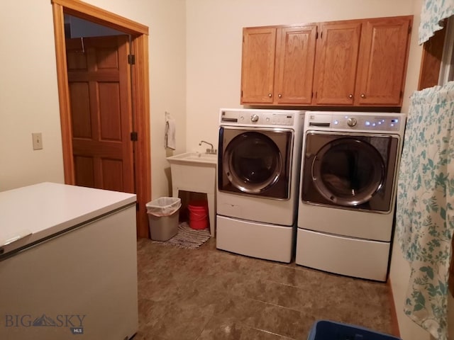 laundry area featuring cabinets, light tile floors, and washing machine and dryer