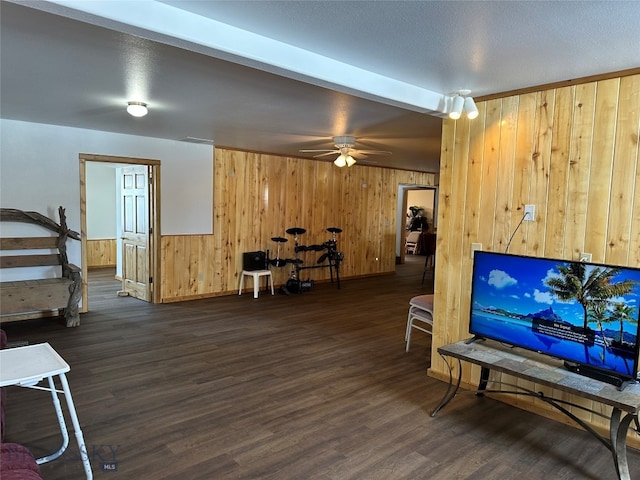 interior space featuring a textured ceiling, ceiling fan, and dark hardwood / wood-style floors