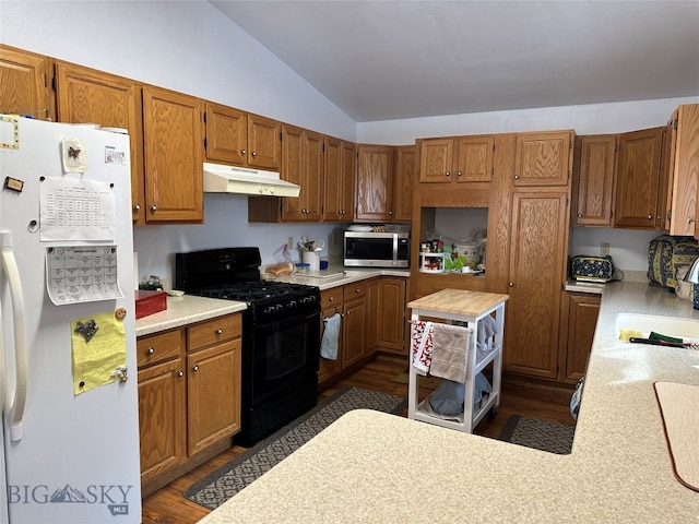 kitchen with white refrigerator with ice dispenser, dark hardwood / wood-style floors, black range with gas stovetop, and lofted ceiling