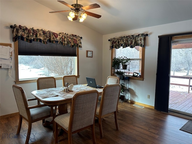 dining room featuring ceiling fan, dark wood-type flooring, and vaulted ceiling