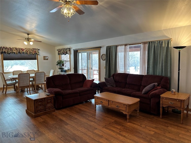 living room featuring ceiling fan and dark hardwood / wood-style floors