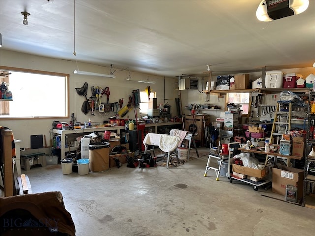 garage with a workshop area and a garage door opener