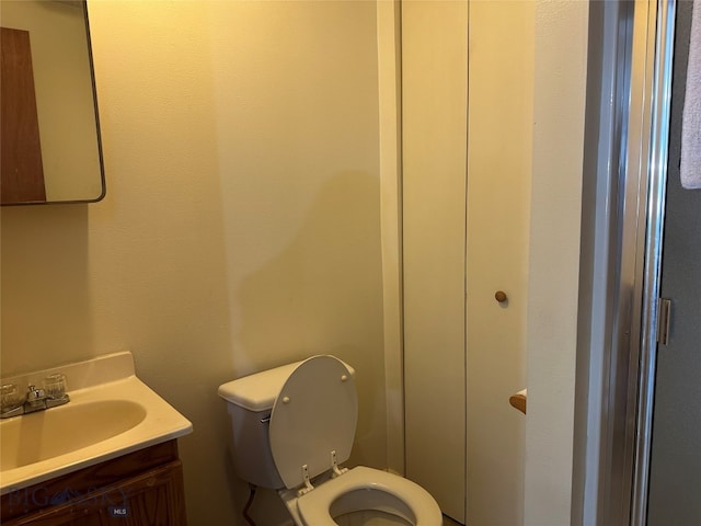 bathroom with toilet and vanity