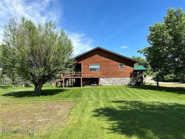 rear view of house with a deck and a lawn