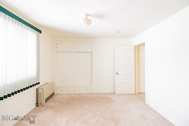 unfurnished room with light colored carpet