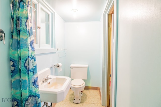 bathroom with sink, tile flooring, and toilet