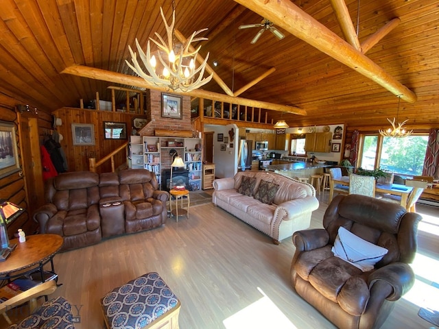 living room featuring wood ceiling, wood walls, ceiling fan with notable chandelier, vaulted ceiling with beams, and light wood-type flooring