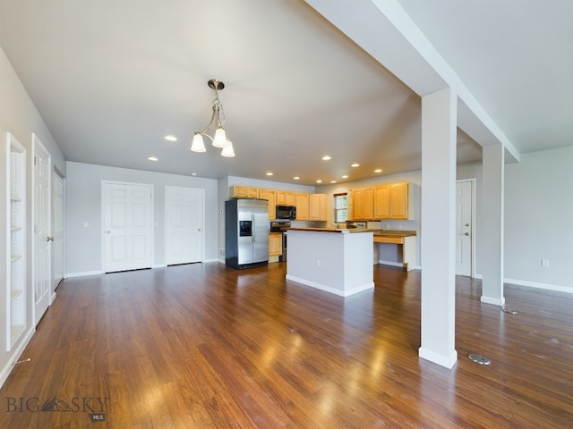 unfurnished living room featuring an inviting chandelier and wood-type flooring