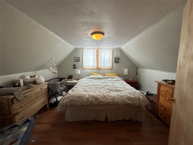 bedroom with a textured ceiling, dark hardwood / wood-style floors, and vaulted ceiling