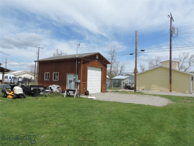 view of shed / structure featuring a yard and a garage