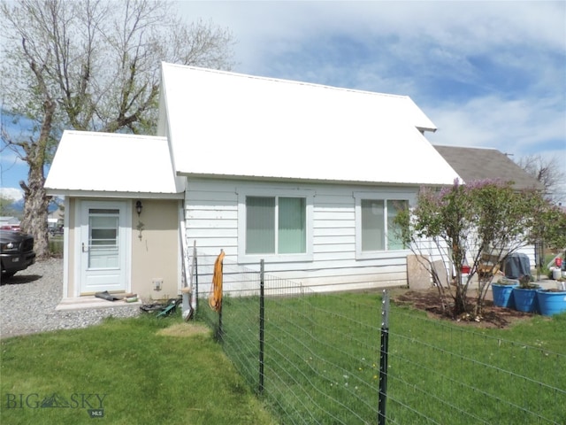 rear view of house with a lawn