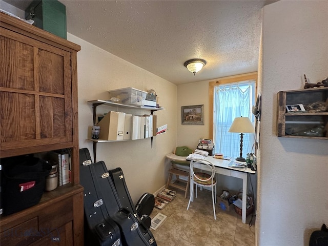 office with a textured ceiling and light tile floors