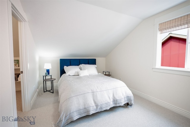 carpeted bedroom featuring vaulted ceiling