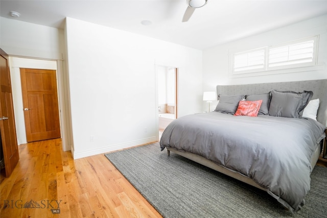 bedroom featuring ensuite bath, light hardwood / wood-style floors, and ceiling fan