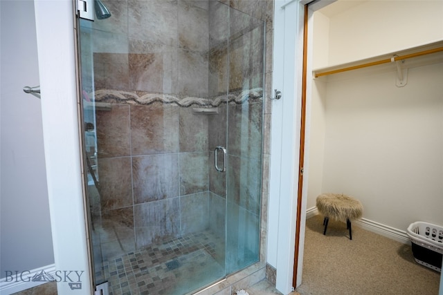 bathroom featuring a shower with door