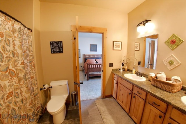 bathroom featuring tile patterned flooring, vanity, and toilet