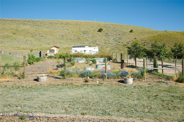 view of yard featuring a mountain view and a rural view