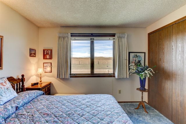 carpeted bedroom with a closet and a textured ceiling