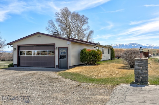 view of front facade with a mountain view, a garage, and an outdoor structure